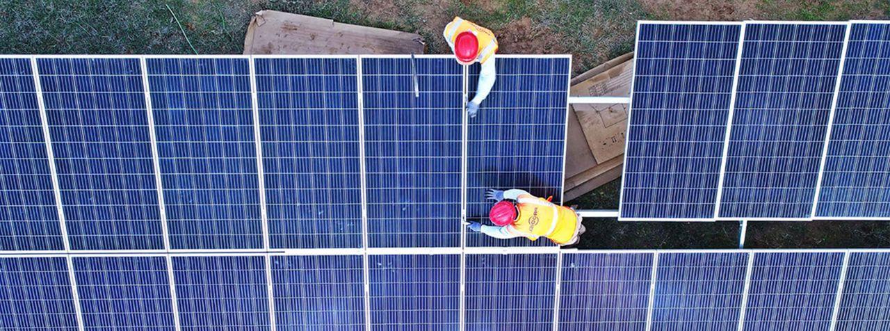 Men working on solar panels