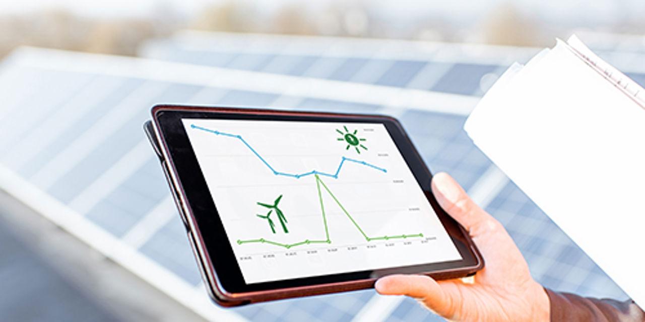 Tablet with graphics in front of solar panels